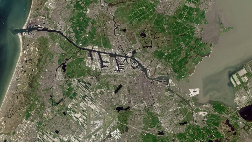 Satellite view of Amsterdam and its surrounding waterways, ports and farmland, illustrating infrastructure exposed to extreme weather