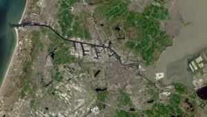 Satellite view of Amsterdam and its surrounding waterways, ports and farmland, illustrating infrastructure exposed to extreme weather