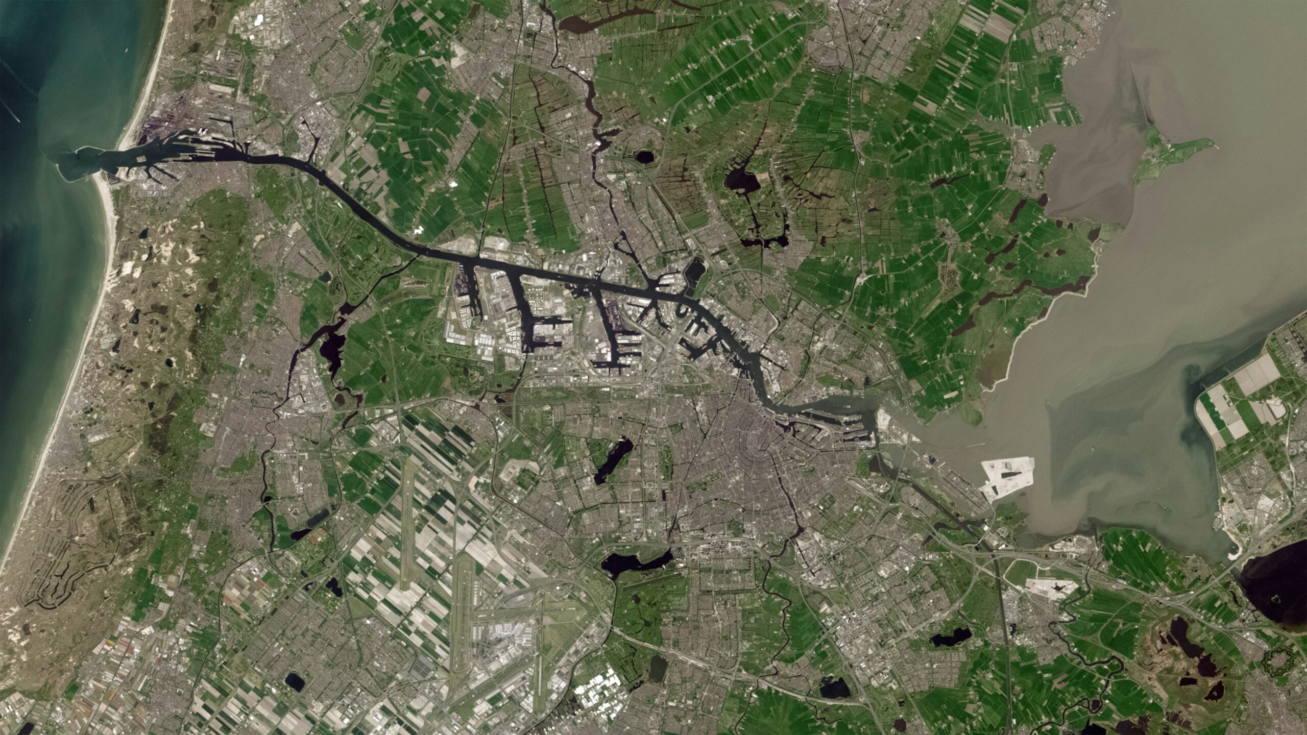 Satellite view of Amsterdam and its surrounding waterways, ports and farmland, illustrating infrastructure exposed to extreme weather